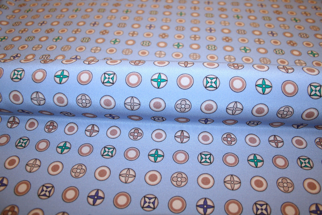 Silke crepe de chine stof med logoprint på lavendel bund